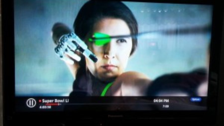 screenshot of ad: Angel Giuffria shooting a bow and arrow with her prosthetic arm and hand.