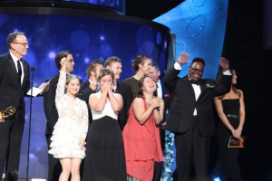 Born This Way cast and producers celebrating their Emmy win on stage at the Emmy Awards. Executive Producer Jonathan Murray holds the Emmy Award.