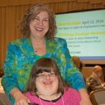 Image of Debra Ruh standing behind her daughter Sara Ruh with a slideshow projector behind them