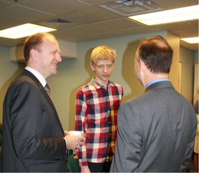 Image of three men speaking