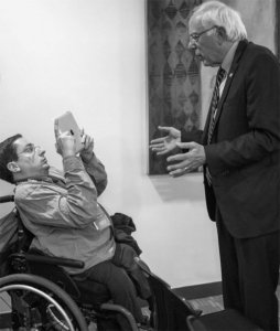 Justin Chappell in a wheelchair interviewing Bernie Sanders using an iPad