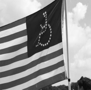 A black and white photo of an American flag with the stars in shape of a wheelchair