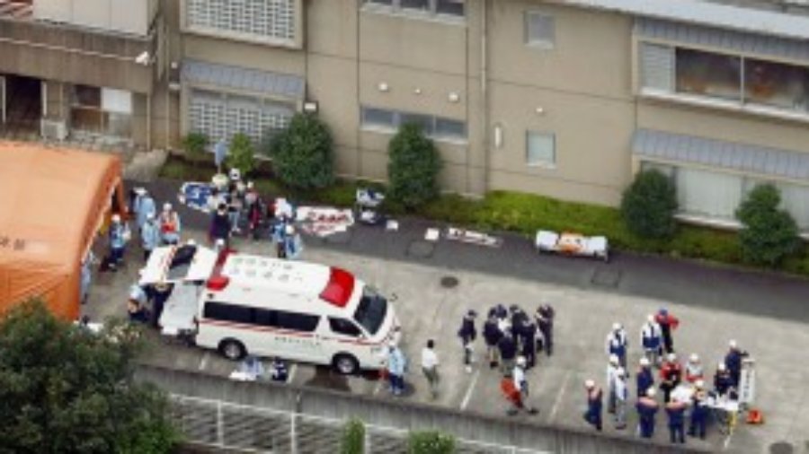 Police officers and rescue workers are seen in a facility for the disabled,