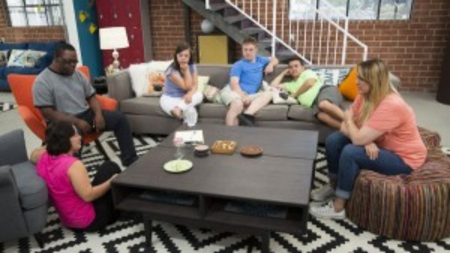 Cast of Born This Way sitting around a table in a living room setting