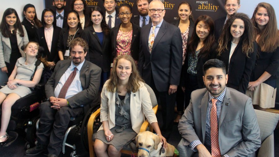 Curt Decker and RespectAbility Fellows standing and seated in a posed photograph, smiling for the camera