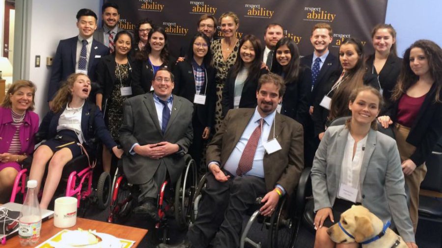 Ami Aronson and RespectAbility Fellows standing and seated in a posed photograph, smiling for the camera