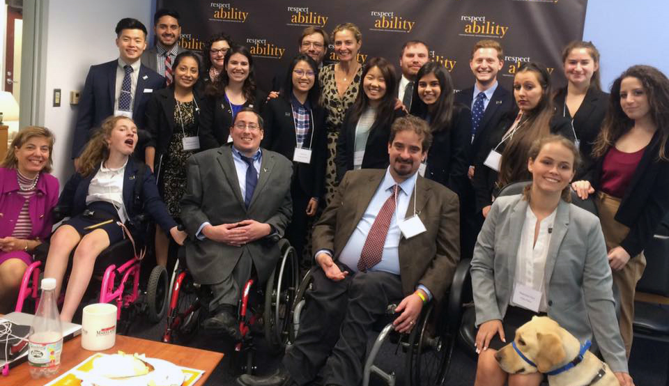 Ami Aronson and RespectAbility Fellows standing and seated in a posed photograph, smiling for the camera