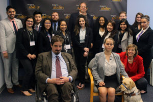 Dan Hazelwood and RespectAbility Fellows standing and seated in a posed photograph, smiling for the camera