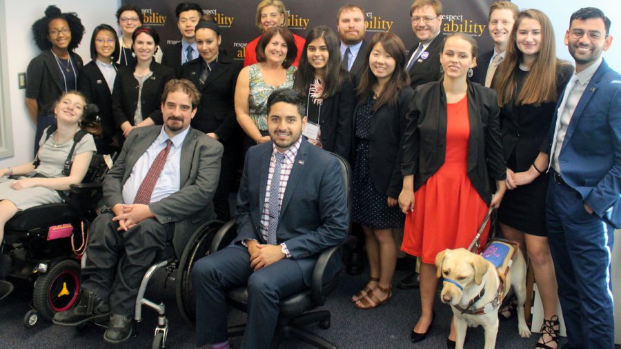 Donna Meltzer and RespectAbility Fellows standing and seated in a posed photograph, smiling for the camera