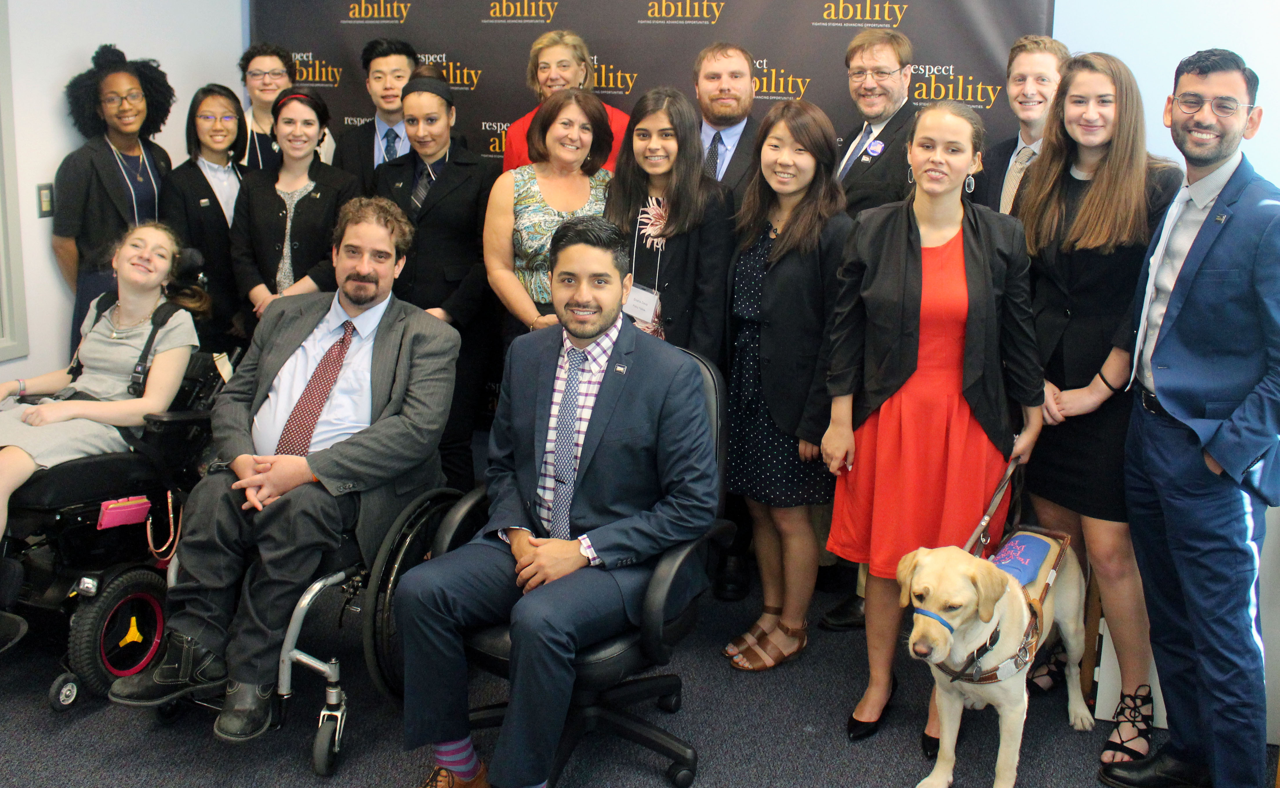 Donna Meltzer and RespectAbility Fellows standing and seated in a posed photograph, smiling for the camera