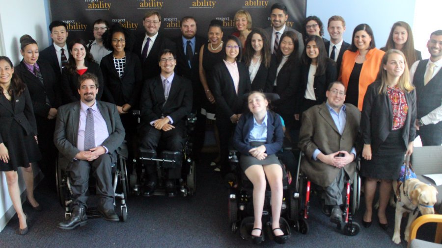 Donna Walton and RespectAbility Fellows standing and seated in a posed photograph, smiling for the camera