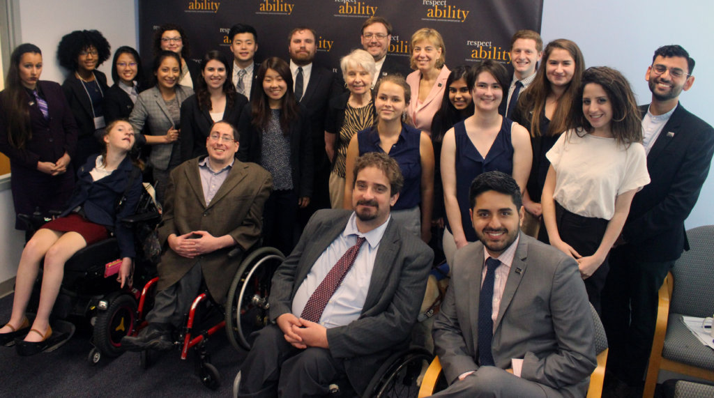 Eleanor Clift and RespectAbility Fellows standing and seated in a posed photograph, smiling for the camera