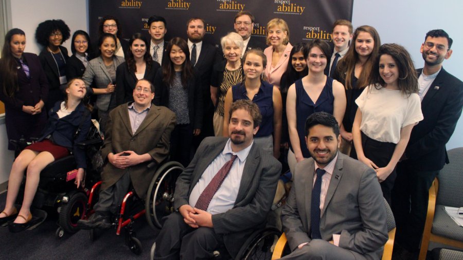 Eleanor Clift and RespectAbility Fellows standing and seated in a posed photograph, smiling for the camera