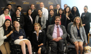 Jonathan Kessler and RespectAbility Fellows standing and seated in a posed photograph, smiling for the camera