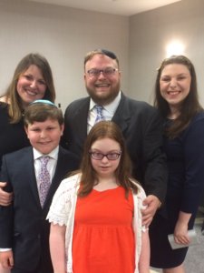 Aaron and Ahuva Orlofsky posed with their three children - teenage girl, boy and girl, all smiling for the camera