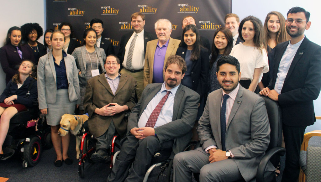 Ron Drach and RespectAbility Fellows standing and seated in a posed photograph, smiling for the camera