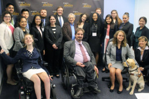 Stan Greenberg and RespectAbility Fellows standing and seated in a posed photograph, smiling for the camera