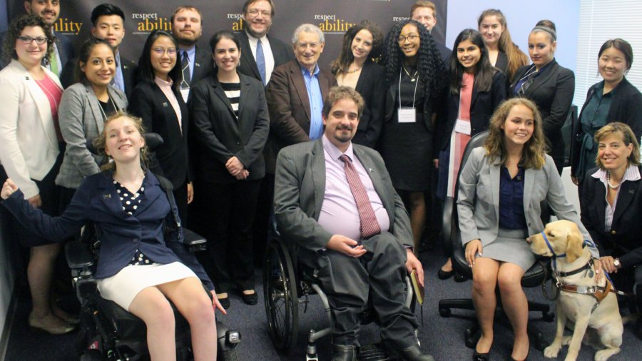 Stan Greenberg and RespectAbility Fellows standing and seated in a posed photograph, smiling for the camera