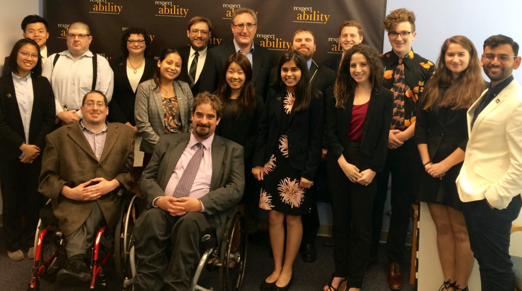 Andy Imparato and RespectAbility Fellows standing and seated in a posed photograph, smiling for the camera