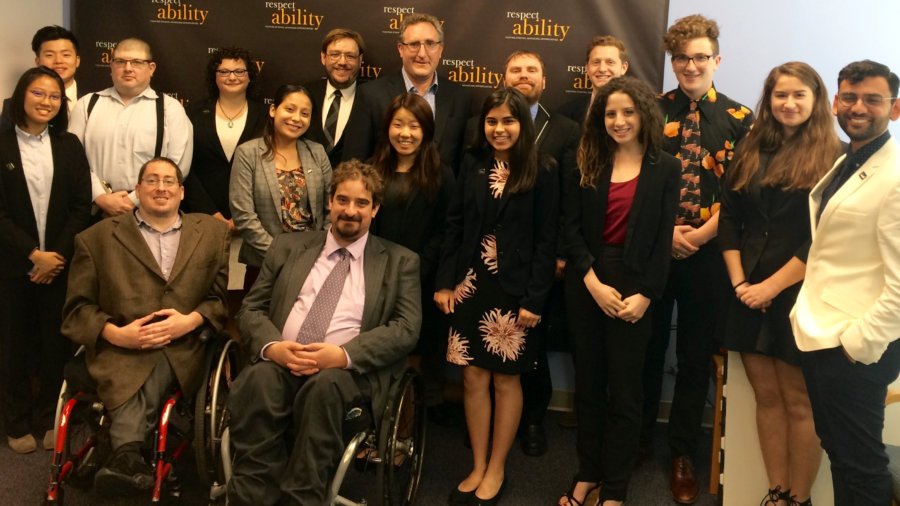 Andy Imparato and RespectAbility Fellows standing and seated in a posed photograph, smiling for the camera