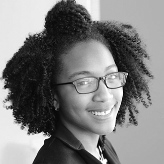 headshot of Brieanna Iyomahan wearing glasses grayscale photo