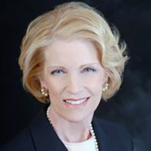 headshot of Dr. Dee Soder who has blonde hair and she is wearing pearl earrings and a pearl necklace color photo