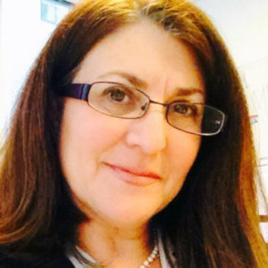 headshot of Donna Meltzer with glasses and wearing her hair loose color photo