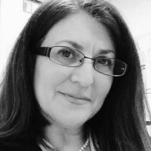 headshot of Donna Meltzer with glasses and wearing her hair loose grayscale photo