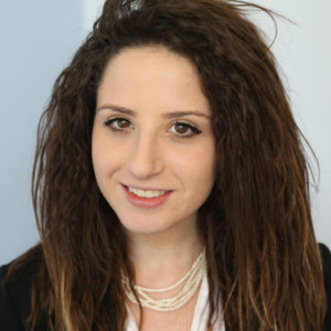 headshot of Ella Issacharoff with loose messy hair color photo