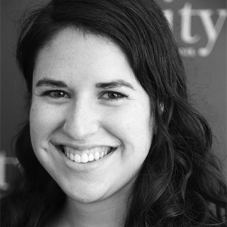 headshot of Hillary smiling at the camera with her hair loose grayscale photo