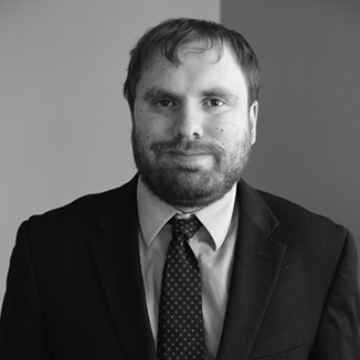 headshot of James Trout wearing suit and tie grayscale photo