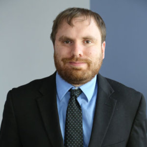 headshot of James Trout wearing suit and tie color photo