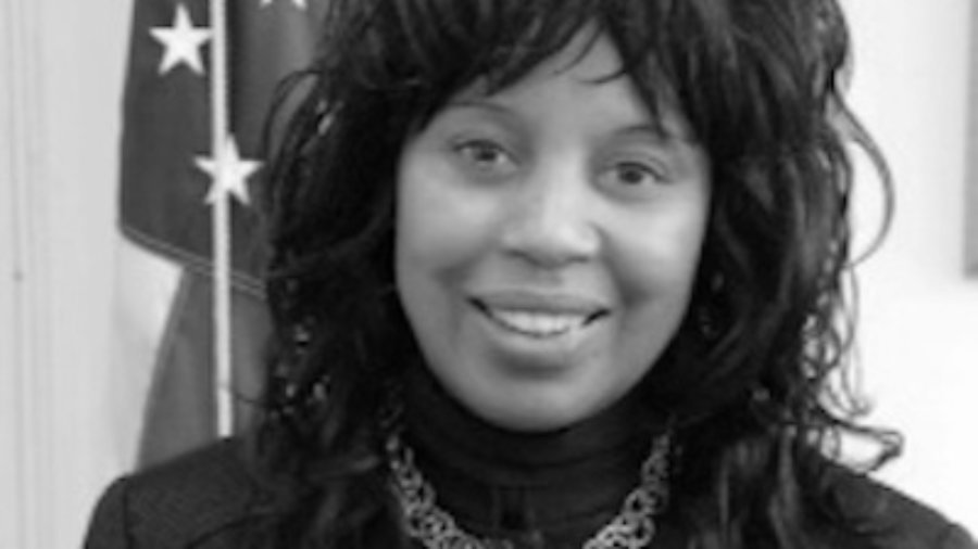 RespectAbility board member Janet LaBreck smiling in front of an American flag