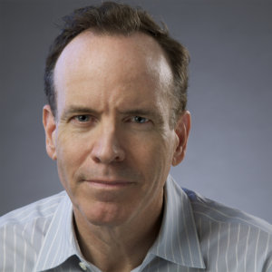 headshot of Jonathan Murray wearing a gray striped shirt and facing the camera color photo