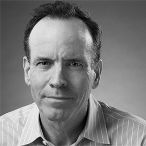 Headshot of Jonathan Murray wearing a striped shirt and facing the camera grayscale photo