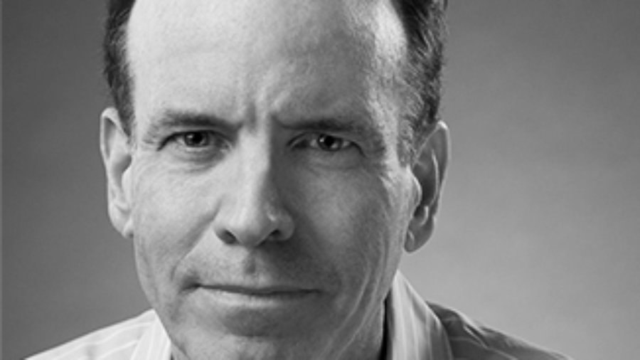 Headshot of Jonathan Murray wearing a striped shirt and facing the camera grayscale photo