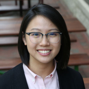 headshot of Judith Lao with glasses on color photo