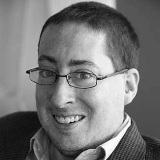 headshot of Justin Chappell wearing glasses grayscale photo