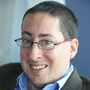 headshot of Justin Chappel wearing glasses color photo