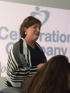 Linda Burger standing and speaking in front of an audience