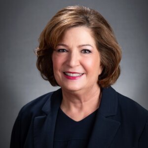 Linda Burger smiling headshot wearing a dark blue blazer