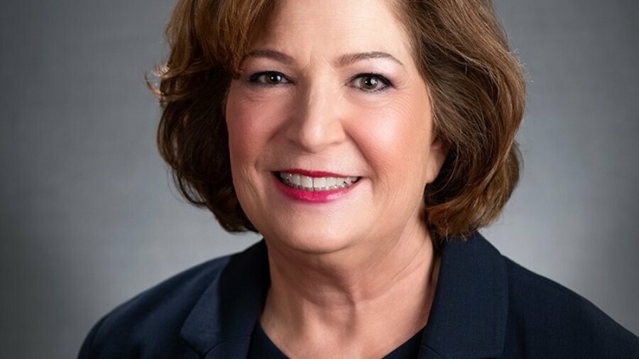 Linda Burger smiling headshot wearing a dark blue blazer