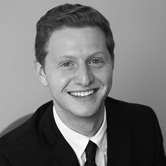 headshot of Matt Lerner wearing a suit and tie grayscale photo