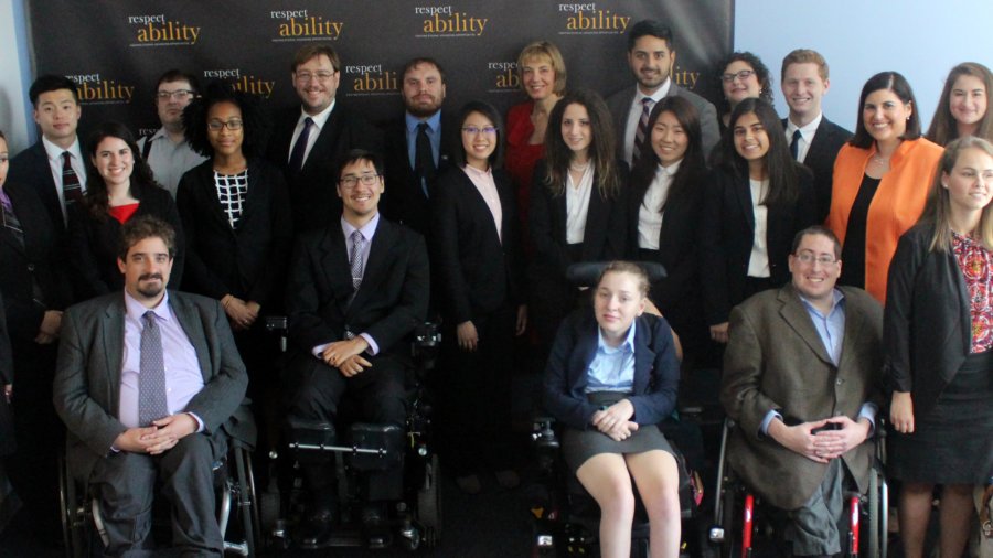 Randy Duchesneau and RespectAbility Fellows standing and seated in a posed photograph, smiling for the camera