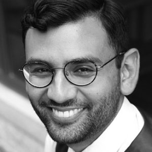 headshot of Ricky Rendon wearing glasses grayscale photo