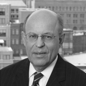 headshot of Ronald Glancz wearing glasses and a striped tie grayscale photo