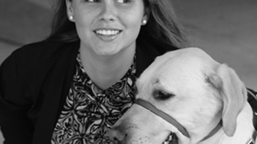 Stephanie Flynt with service dog Nala in grayscale