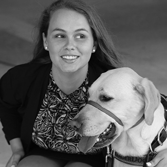 Stephanie Flynt with service dog Nala in grayscale