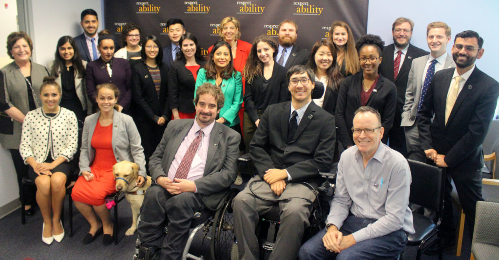 All of the fellows and staff standing in a large group against the wall with the RespectAbility logo all over it