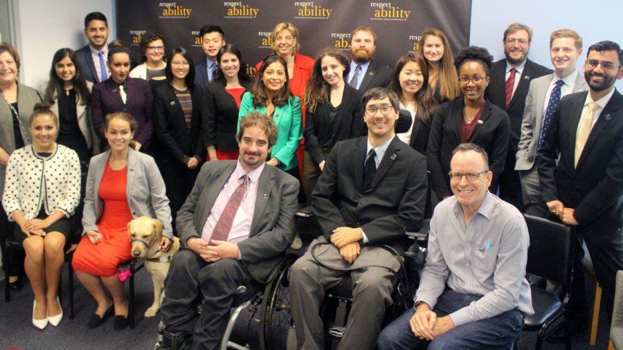 All of the fellows and staff standing in a large group against the wall with the RespectAbility logo all over it